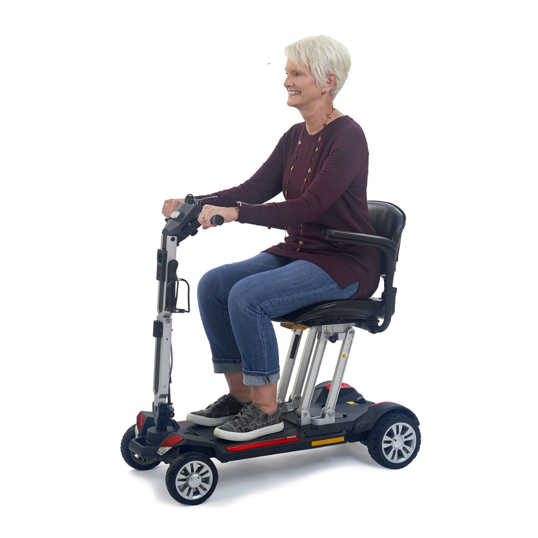 Golden Tech Buzzaround Carry-On Folding Travel Scooter with Travel Battery - with female senior rider