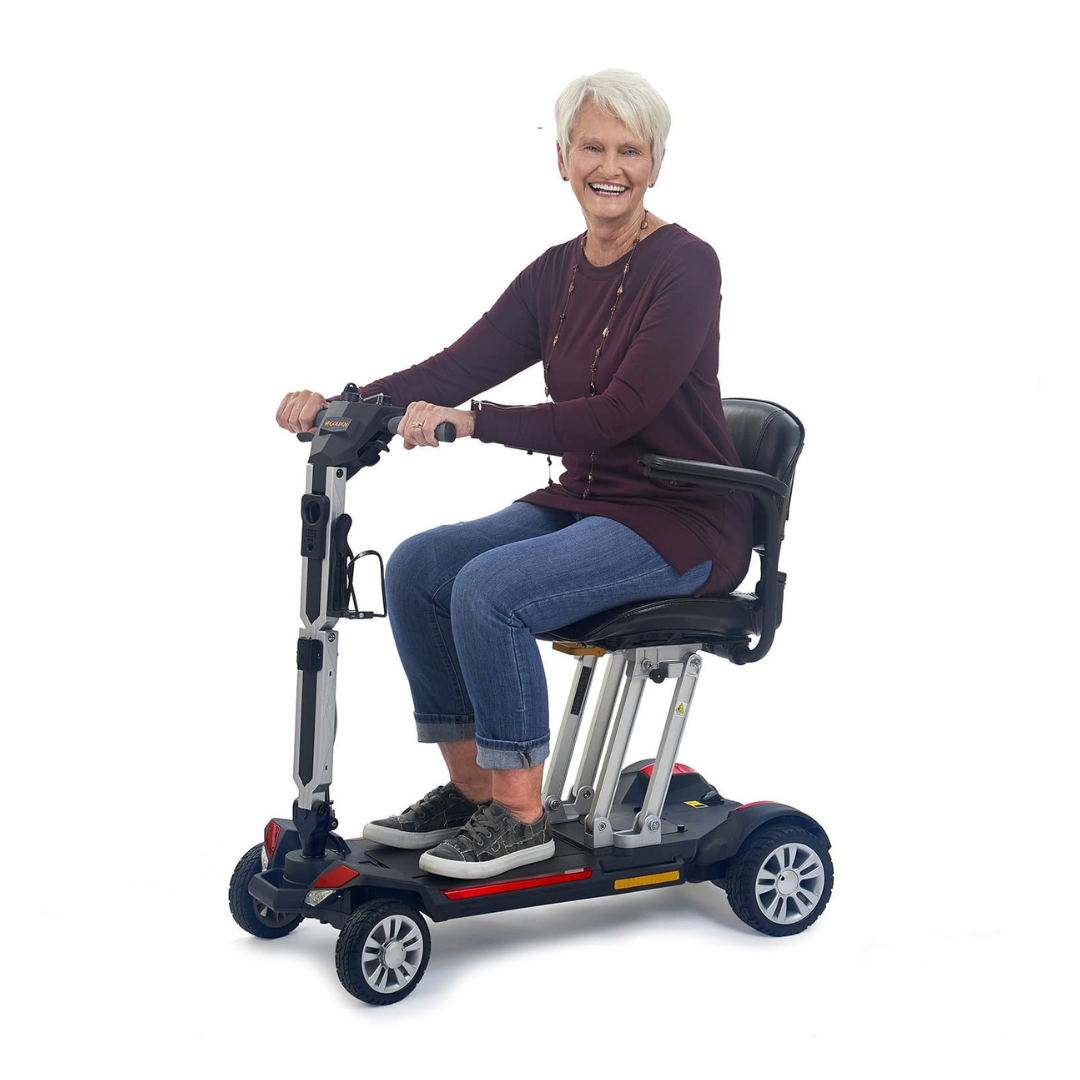 Golden Tech Buzzaround Carry-On Folding Travel Scooter with Travel Battery - with female senior rider