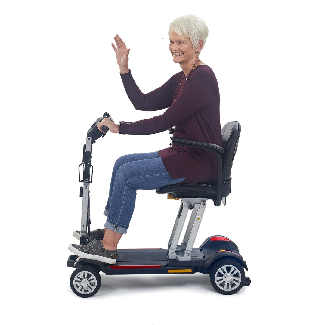 Golden Tech Buzzaround Carry-On Folding Travel Scooter with Travel Battery - with female senior rider