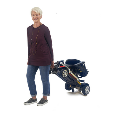 Golden Tech Buzzaround Carry-On Travel Scooter with Travel Battery and Protective Case - with senior pulling the scooter