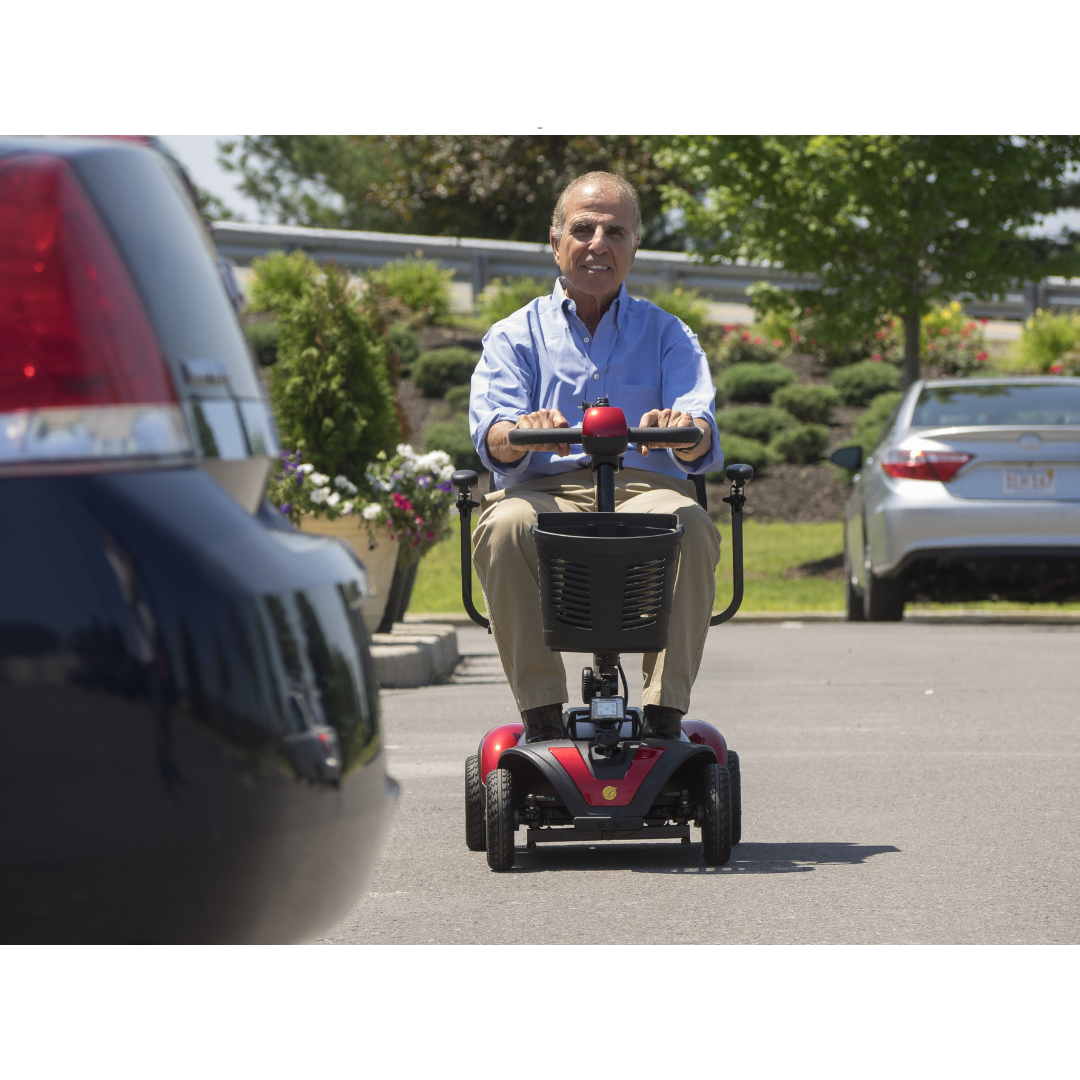 Golden Tech Buzzaround LX Extreme Luxury Full Size Travel Mobility Scooter - 4 Wheel - being operated over asphalt