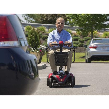 Golden Tech Buzzaround LX Extreme Luxury Full Size Travel Mobility Scooter - 4 Wheel - being operated over asphalt