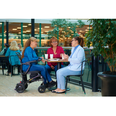 Golden Tech Cricket Carbon Fiber Foldable Travel Power Wheelchair - with user dining