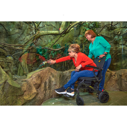 Golden Tech Cricket Carbon Fiber Foldable Travel Power Wheelchair - with user operating indoor